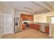 Bright kitchen with stainless steel appliances, wood cabinets, and sleek countertops at 3151 Sinclair St # 104, Orlando, FL 32835