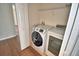 This laundry room is equipped with a newer model Samsung washer and dryer and a storage shelf at 3151 Sinclair St # 104, Orlando, FL 32835