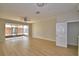 Bright living room featuring hardwood floors and sliding glass doors leading to an enclosed patio at 3151 Sinclair St # 104, Orlando, FL 32835