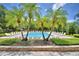 Community pool with lush landscaping, lounge chairs, and a relaxing atmosphere at 3151 Sinclair St # 104, Orlando, FL 32835