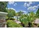 Landscaped pool area with lush greenery, palm trees, and lounge chairs at 3151 Sinclair St # 104, Orlando, FL 32835