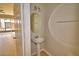 Cozy powder room featuring a pedestal sink and neutral decor at 3151 Sinclair St # 104, Orlando, FL 32835