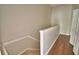 Staircase featuring painted walls, white trim, and wooden floors at 3151 Sinclair St # 104, Orlando, FL 32835