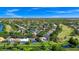 Aerial shot of a golf community home featuring a pool, mature trees, and water view at 3170 Zaharias Dr, Orlando, FL 32837
