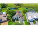 Aerial view of home with pool, mature trees, and pond and a water view at 3170 Zaharias Dr, Orlando, FL 32837