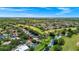 Aerial view of a golf community home featuring a pool, mature trees, and water view at 3170 Zaharias Dr, Orlando, FL 32837