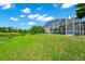 The backyard features a covered screened-in lanai and a spacious lawn at 3170 Zaharias Dr, Orlando, FL 32837
