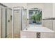Bathroom featuring bathtub and glass shower with beige tile at 3170 Zaharias Dr, Orlando, FL 32837