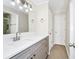 Bathroom vanity featuring sleek gray cabinets, countertop and a large mirror at 3170 Zaharias Dr, Orlando, FL 32837