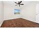 This cozy bedroom offers wood floors, a ceiling fan, and natural light at 3170 Zaharias Dr, Orlando, FL 32837