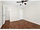 Well-lit bedroom with hardwood floors, closet, and neutral walls creating a cozy feel at 3170 Zaharias Dr, Orlando, FL 32837
