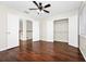 This bedroom offers a ceiling fan, wood floors, and multiple closets for storage solutions at 3170 Zaharias Dr, Orlando, FL 32837