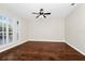 Bright bedroom showcasing hardwood floors, plantation shutters, and a ceiling fan at 3170 Zaharias Dr, Orlando, FL 32837