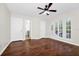 Spacious bedroom with hardwood flooring, ceiling fan, and natural light, perfect for relaxation at 3170 Zaharias Dr, Orlando, FL 32837