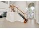 Welcoming foyer featuring tile flooring, stairs with wood railing, and natural light at 3170 Zaharias Dr, Orlando, FL 32837