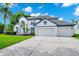 Two-story house with a spacious two-car garage, and a well manicured green lawn at 3170 Zaharias Dr, Orlando, FL 32837