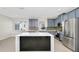 Bright kitchen with gray cabinetry, stainless appliances, mosaic backsplash, and large island with seating at 3170 Zaharias Dr, Orlando, FL 32837