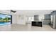 Open floor plan showcasing kitchen with gray cabinets and pool view through large sliding doors at 3170 Zaharias Dr, Orlando, FL 32837
