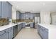 Spacious kitchen with gray cabinets, stainless appliances, and a large white quartz countertop at 3170 Zaharias Dr, Orlando, FL 32837