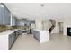 Modern kitchen with gray cabinets, stainless steel appliances, quartz countertops, and an island at 3170 Zaharias Dr, Orlando, FL 32837