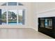 Open living room with tile floors, fireplace, white trim, and a view of the pool at 3170 Zaharias Dr, Orlando, FL 32837