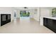 Spacious living area with fireplace and sliding doors leading to a pool with kitchen view at 3170 Zaharias Dr, Orlando, FL 32837