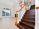 Living room featuring staircase with dark wood and view of the pool through window at 3170 Zaharias Dr, Orlando, FL 32837