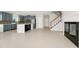 Open floor plan featuring kitchen, staircase, and fireplace with spacious tile flooring at 3170 Zaharias Dr, Orlando, FL 32837