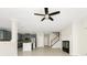 Open floor plan showcasing the kitchen, staircase, and fireplace in a bright living area at 3170 Zaharias Dr, Orlando, FL 32837