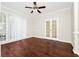 Cozy living room with wood floors, large window, ceiling fan, and white trim at 3170 Zaharias Dr, Orlando, FL 32837