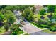 Picturesque street view of a residential entrance, lined with mature trees and a well-maintained stone wall at 3170 Zaharias Dr, Orlando, FL 32837