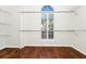 Walk-in closet with hardwood floors and window with half shutter at 3170 Zaharias Dr, Orlando, FL 32837