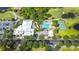 Aerial view of the community pool, tennis courts, clubhouse, and surrounding neighborhood at 3378 Sagebrush St, Harmony, FL 34773