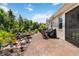 Spacious brick patio with outdoor seating and a lush landscaped backyard at 3378 Sagebrush St, Harmony, FL 34773