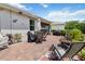 Spacious brick patio features multiple seating areas, outdoor cooking space, and lush landscaping at 3378 Sagebrush St, Harmony, FL 34773