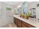 This bright bathroom features a double sink vanity, walk-in shower, and large vanity mirror at 3378 Sagebrush St, Harmony, FL 34773