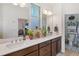 This bright bathroom features a double sink vanity and access to a toilet room at 3378 Sagebrush St, Harmony, FL 34773