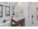 Neutral bathroom featuring a white vanity, framed artwork, and modern fixtures at 3378 Sagebrush St, Harmony, FL 34773