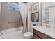 Well-lit bathroom with a shower-tub combination, framed artwork, and vanity with modern faucet at 3378 Sagebrush St, Harmony, FL 34773