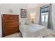Well-lit bedroom featuring a classic wooden dresser, and soft, inviting bedding at 3378 Sagebrush St, Harmony, FL 34773