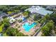 Aerial view of the beautiful community pool with lounge seating and mature landscaping at 3378 Sagebrush St, Harmony, FL 34773