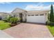 Exterior of house with brick driveway and manicured landscaping at 3378 Sagebrush St, Harmony, FL 34773