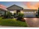 Charming home boasts beautiful landscaping, well-lit entry, brick driveway, and a two-car garage at 3378 Sagebrush St, Harmony, FL 34773