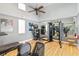 Functional gym with cardio equipment, weight racks, and mirrored walls, maximizing space and workout potential at 3378 Sagebrush St, Harmony, FL 34773