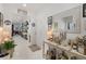Long, bright hallway with white tile and decorative elements leading to the living areas at 3378 Sagebrush St, Harmony, FL 34773