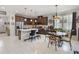 Open-concept kitchen and dining area, featuring stainless steel appliances and stylish furnishings at 3378 Sagebrush St, Harmony, FL 34773