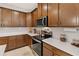 Detailed kitchen with stainless appliances, modern cabinets, and white countertops at 3378 Sagebrush St, Harmony, FL 34773