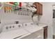 Functional laundry room featuring a washer, dryer, sink, and upper cabinets for ample storage at 3378 Sagebrush St, Harmony, FL 34773