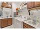 Organized laundry room with a washer, dryer, sink, and storage cabinets at 3378 Sagebrush St, Harmony, FL 34773
