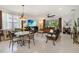 Bright open-concept living room features tiled floors, comfortable seating and backyard views at 3378 Sagebrush St, Harmony, FL 34773